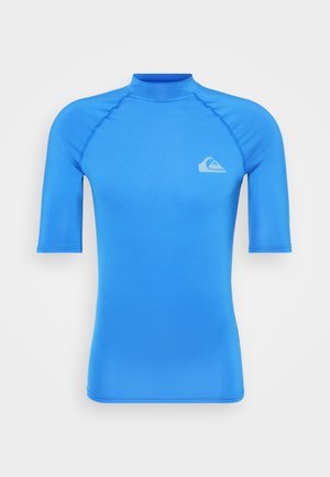 Rash guard a maniche corte di colore blu brillante, realizzato in materiale morbido ed elastico. Presenta un collo alto e un piccolo logo sul petto.