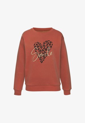 Terracotta sweatshirt with a crew neckline, featuring a leopard print heart and the word "Smile" in gold script. Soft, textured fabric.