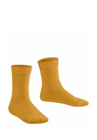 Deux chaussettes jaunes avec des bords côtelés, présentées sur un fond blanc, montrant clairement leur texture et leur forme.