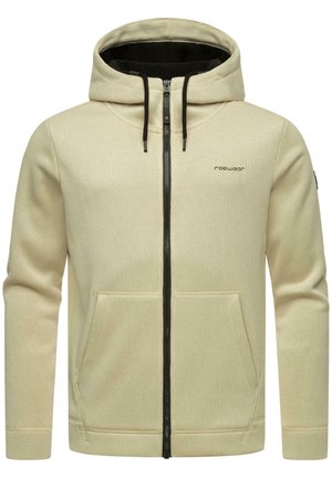 Cream zip-up hoodie with a black zipper, front pockets, thick fabric, drawstring hood, and subtle logo on the left chest.