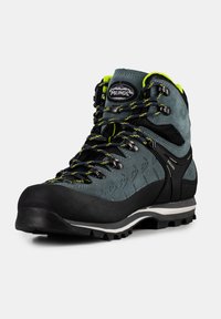 Dunkelgrauer Wanderschuh mit einem Obermaterial aus Wildleder und Synthetik, schwarzer Gummispitze, gelben Akzenten und einer strukturierten Gummisohle.