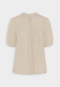 Blusa beige a maniche corte con colletto alla mandarino, chiusura con bottoni e una tasca sul petto. Realizzata in un tessuto leggero e liscio.