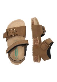 Braune Wildledersandalen mit zwei verstellbaren Riemen und einer Schnalle. Texturierte Kork-ähnliche Sohle und flacher Absatz für den Freizeitgebrauch.
