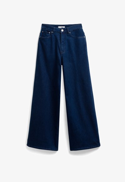 Laivansiniset leveälahkeiset farkut, joissa on korkea vyötärö, viiden taskun perusdesign ja edessä nappisuljenta. Sileä rakenne.