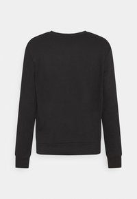 Sweat-shirt noir à manches longues avec col rond, poignets et ourlet côtelés, présenté de dos sur un fond gris clair.