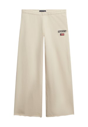 Beige wijde broek gemaakt van gladde stof, met een elastische tailleband en geborduurd "SUPERDRY" logo met een klein detail van de Amerikaanse vlag.