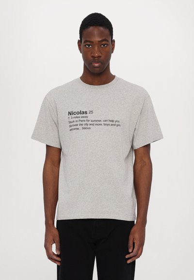 Gray cotton T-shirt featuring short sleeves and a crew neckline. Text on the front includes name and location details in black ink.