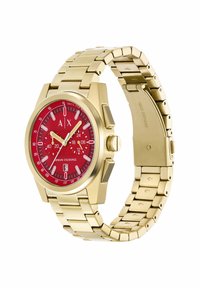 Orologio in acciaio inox dorato con quadrante analogico rosso, marcatori bianchi e funzione data; presenta un design a bracciale a maglie.