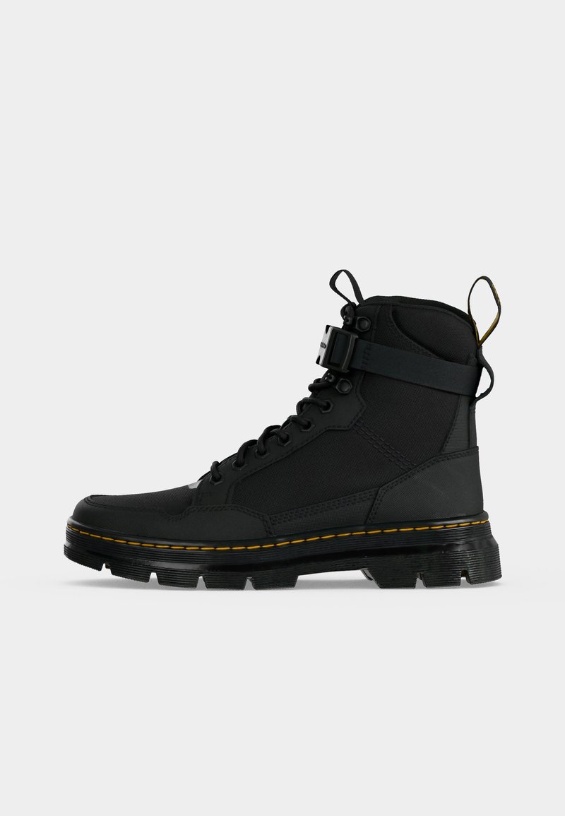 Black high-top lace-up boot with chunky sole, yellow stitching detail, and a buckle strap around the ankle.