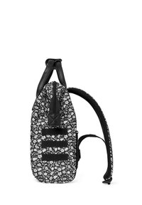 Black and white floral-patterned backpack with leather accents, a zip closure, and adjustable straps. Features multiple front strap details.
