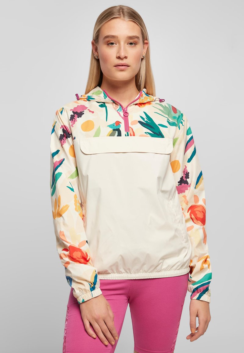 Leichte, mehrfarbige Pullover-Jacke mit Blumenmustern, einem halbseitigen Reißverschluss vorne, elastischen Bündchen und einer Fronttasche. Glatte Stoffstruktur.