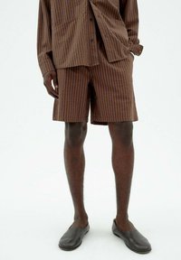 Striped brown shirt and matching shorts made of lightweight fabric. The design features vertical stripes in dark brown on a lighter brown background.
