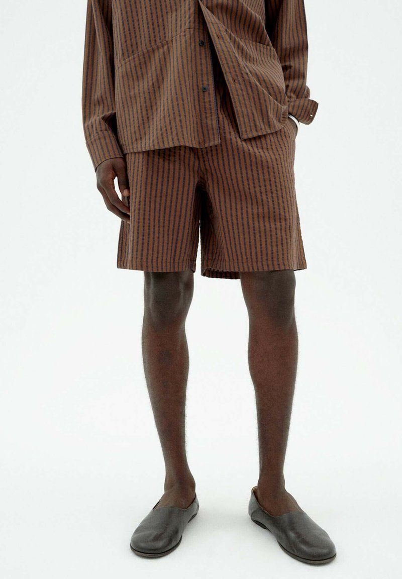 Striped brown shirt and matching shorts made of lightweight fabric. The design features vertical stripes in dark brown on a lighter brown background.