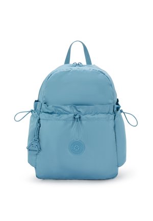 Light blue backpack featuring a rounded design, cap closure, adjustable drawstring, side pockets, and a logo badge on the front.