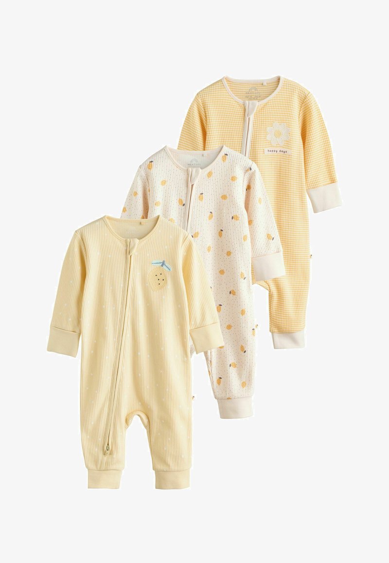 Trys geltoni ilgomis rankovėmis kūdikių kombinezonai su užtrauktuku priekyje, puošti vaisių ir gėlių raštais švelniomis pastelinėmis spalvomis.