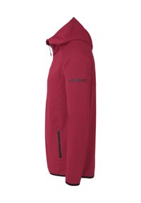 Rød hættejakke lavet af blødt stof. Har en tætsiddende silhuet, sort lynlåslomme og "uhlsport" logo på venstre ærme.