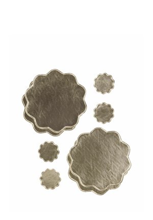 Eight gold metallic flower-shaped coasters in two large stacks and four single pieces, displayed on a white background.