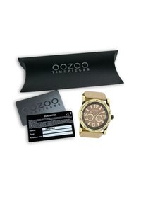 Montre-bracelet dorée avec un cadran marron, un bracelet en cuir beige, deux sous-cadrans et des chiffres arabes. Comprend l'emballage et la carte de garantie.