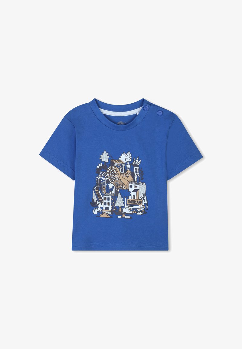 Blauwe T-shirt met korte mouwen van katoen, met een grafische print van een laars en gebouwen, en knopen op de schouder voor gemakkelijke aan- en uittrekken.