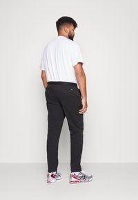 Calvin Klein GARMENT BELT - Chinos - black