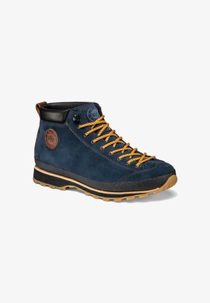 Navy blue suede hiking boot with yellow laces, black padded collar, brown pull tab, and textured tan rubber sole.