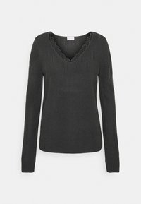 Svart stickad tröja med långa ärmar, V-ringning och scallopkant längs ringningen. Medelvikts och texturerat tyg.