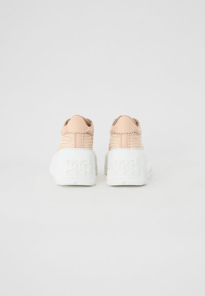 Pink woven sneakers with a textured upper and white chunky soles. Features embossed logo on the heel and a rounded toe design.