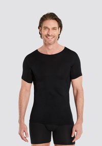 Black short-sleeve t-shirt with a round neckline, made of stretchable fabric. Smooth texture, fitted design, worn over black briefs.