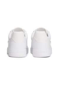 Paire de baskets basses blanches vues de dos, avec col matelassé et nom de marque embossé sur les semelles intermédiaires.