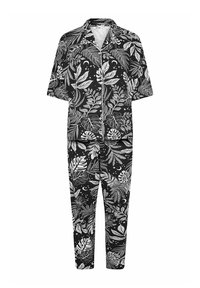 Svart och vit pyjamasset med kortärmad skjorta och långa byxor, prydd med ett bladmönster och himmelska motiv. Mjuk stil.
