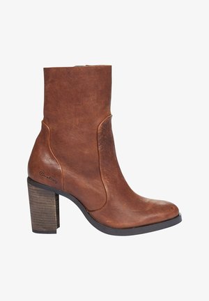 Brown leather ankle boot with a smooth texture, rounded toe, and side slits. Features a block heel and subtle branding on the side.