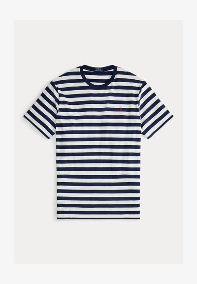 Jūklā un baltā svītraina t-kreklu ar īsām piedurknēm, apaļa kakla izgriezums un neliels sarkans logo kreisajā krūtī. Izgatavots no kokvilnas, gluda tekstūra.