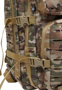 Camo backpack featuring durable fabric, multiple compartments, tan straps, and buckle closures, highlighting a tactical design and functionality.