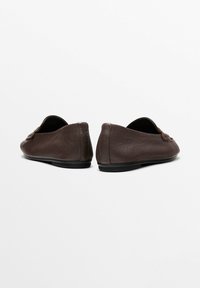 Brown leather loafers with a smooth texture, low profile, and rounded shape. Simple design with no visible hardware or patterns.