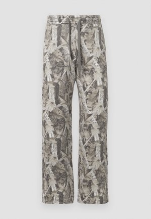 Camo-print pants featuring a relaxed fit, gray and beige color palette, elastic waistband with drawstring, and soft fabric texture.