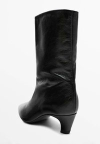 Black leather ankle boot with a rounded toe, smooth texture, and a modest heel. Features a classic silhouette and seamless construction.