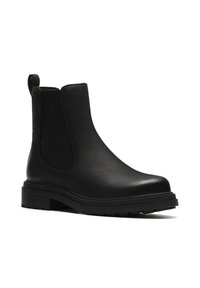 Bottines en cuir noir avec des panneaux élastiques latéraux, un bout arrondi et une semelle en caoutchouc texturé pour une meilleure adhérence et durabilité. Design minimaliste.