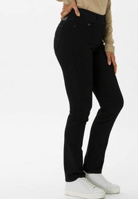 Jeans skinny neri realizzati in tessuto misto cotone, con un classico design a cinque tasche, vita a media altezza e dettagli di cucitura sottili.