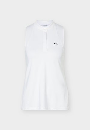 Αμάνικο λευκό πόλο με ψηλό γιακά, πατιλέτα με κουμπιά και μικρό μαύρο λογότυπο στο αριστερό μέρος του στήθους.