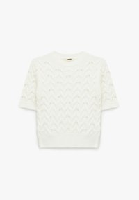 Valkoinen cable-knit lyhythihainen neulepaita, jossa on teksturoitu pinta ja pieniä koristeita ympäriinsä. Ribbbireunaiset pyöreät kaula-auko ja helma.