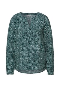 Tealblus med långa ärmar, V-hals och geometriskt vitt mönster överallt. Tillverkad av mjukt tyg med en avslappnad passform och böjd nederkant.