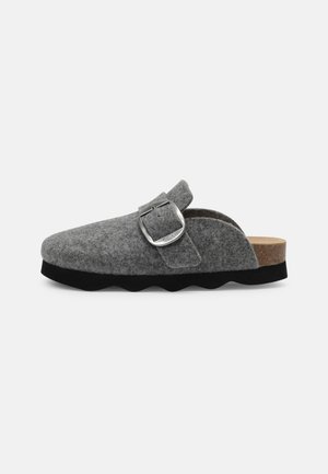 Gray felt slipper with a silver metal buckle, cork footbed, and black rubber sole. Features a slip-on design with wavy edges.