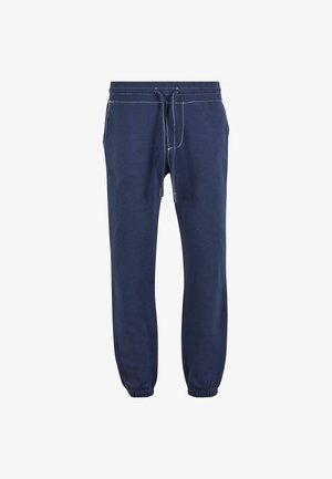 Námorníckomodré tepláky vyrobené z mäkkej tkaniny s pásom na šnurovanie, elastickými manžetami a kontrastným bielym prešívaním.