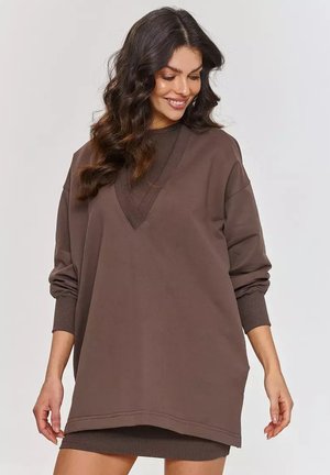 Brązowa, oversize'owa bluza z głębokim dekoltem w serek, długimi rękawami i ściągaczami. Miękka faktura i casualowy design idealny do noszenia w warstwach.