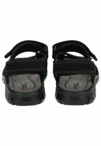 Schwarze Sandalen mit verstellbaren Riemen, strukturiertem Fußbett und Gummisohle. Die Rückansicht zeigt Polsterung in der Nähe des Knöchels und das Logo auf der Innensohle.