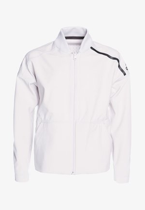 Veste blanche zippée avec col montant, deux poches frontales et une bande d'accent noire sur l'épaule gauche. Texture lisse.