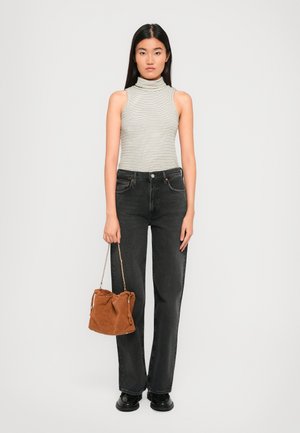 Striped sleeveless turtleneck top, black high-waisted jeans, brown suede bucket bag with a chain strap, and black platform shoes.