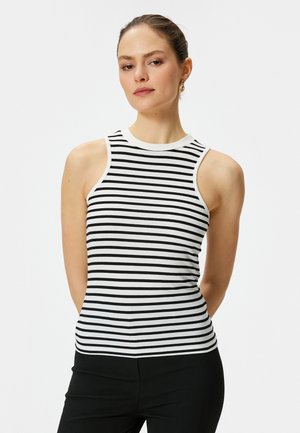 Rippentop in Schwarz-weiß-Streifen, mit hohem Kragen und ärmellosem Design. Strukturierter Strickstoff mit figurnahem Schnitt.