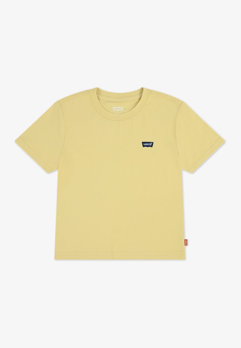 Κίτρινη βαμβακερή μπλούζα με κοντά μανίκια, ριμπ λαιμόκοψη και ένα μικρό μπλε λογότυπο. Διαθέτει ίσιο τελείωμα και διακριτικές λεπτομέρειες ραφής.