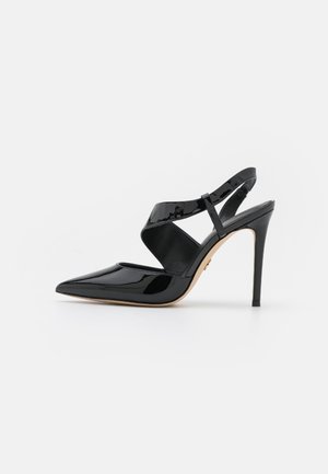 Czarne lakierowane buty na obcasie typu slingback z noskiem w szpic i zdobieniami z krzyżujących się pasków na białym tle.